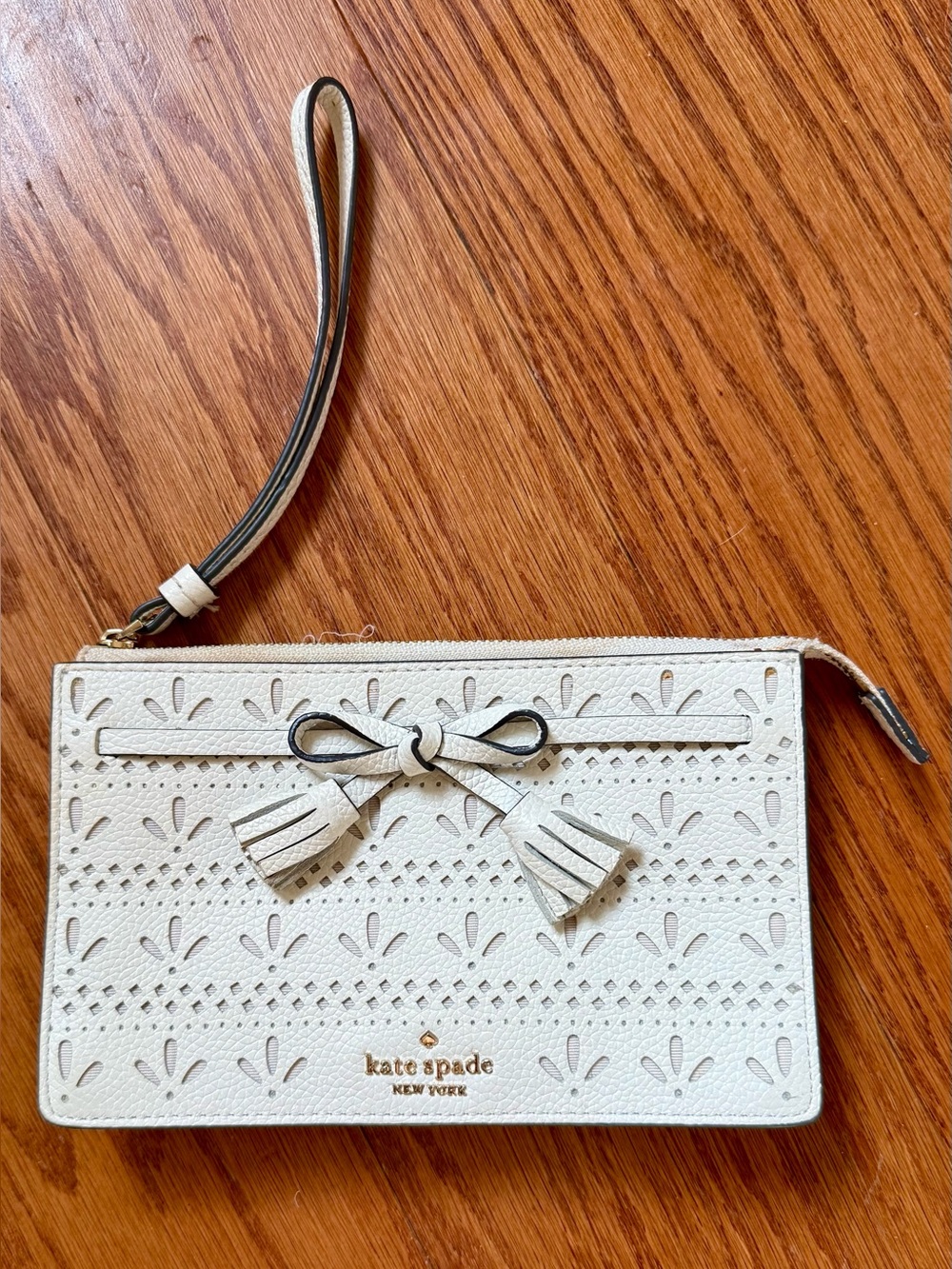 kate spade White Perforated Leather Wristlet with Bow Tassels